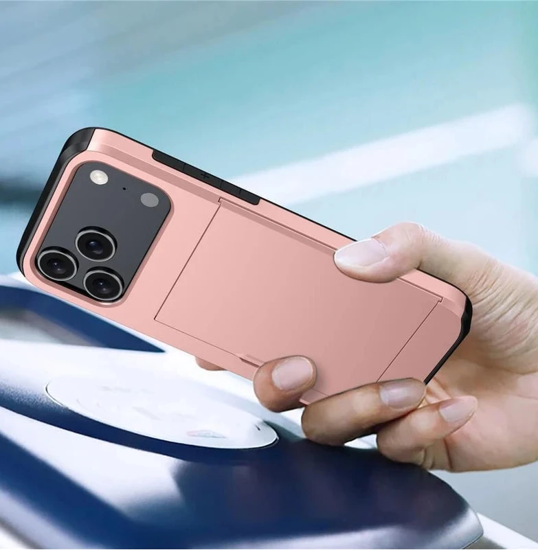 A hand holding a smartphone with a metallic rose gold protective case featuring a built-in rectangular card slot on the back